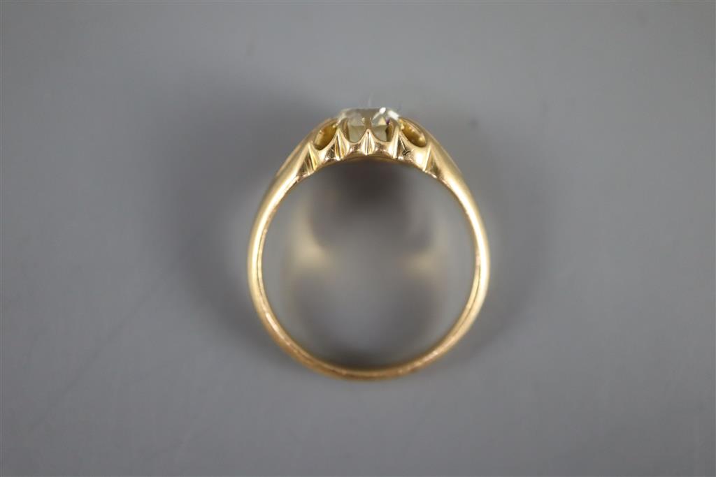 An early 20th century gold and old cushion cut claw set solitaire diamond ring, with fluted shoulders,